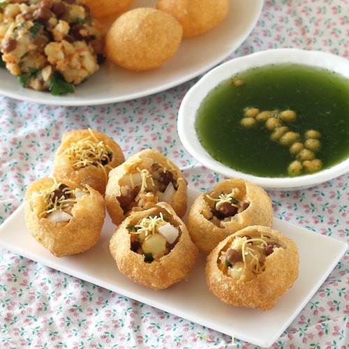 Pani Puri (A flour crisp stuffed with peas and served with spiced water)